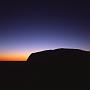 Der Uluru - auch Ayers Rock genannt -ganz früh morgens zu Beginn des Sonnenaufgangs